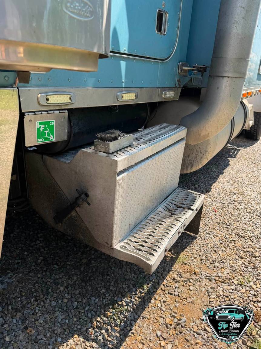 The sleeper cab and polished entry steps of a blue semi truck