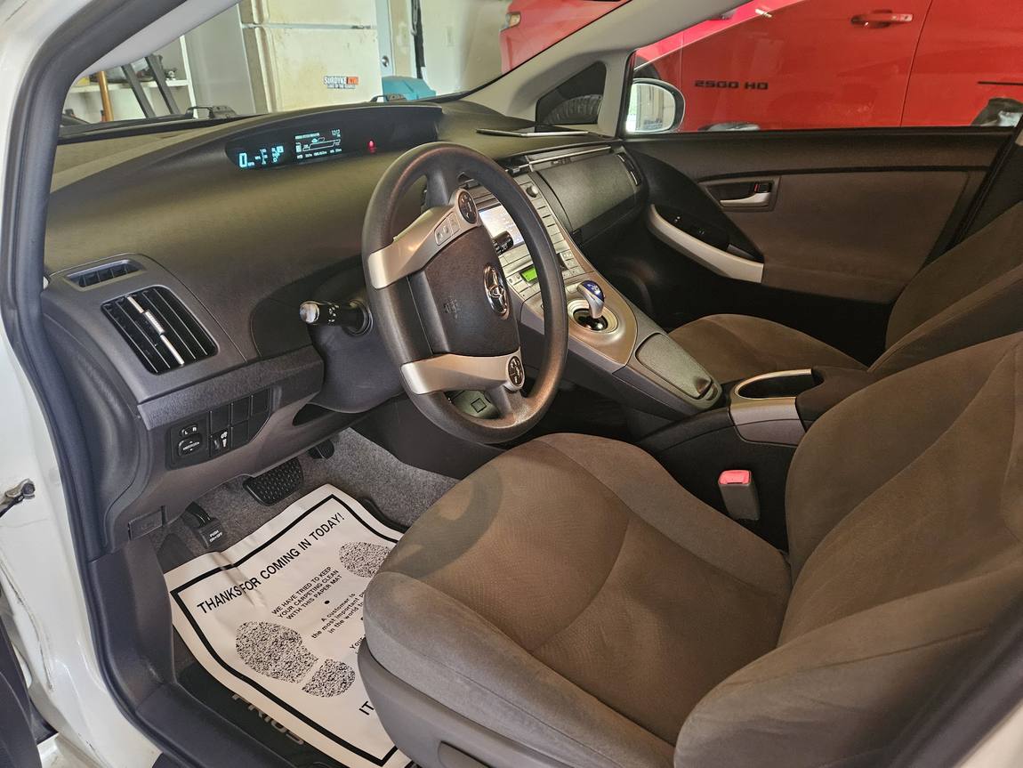 A detailed car interior with clean seats, carpet and dashboard