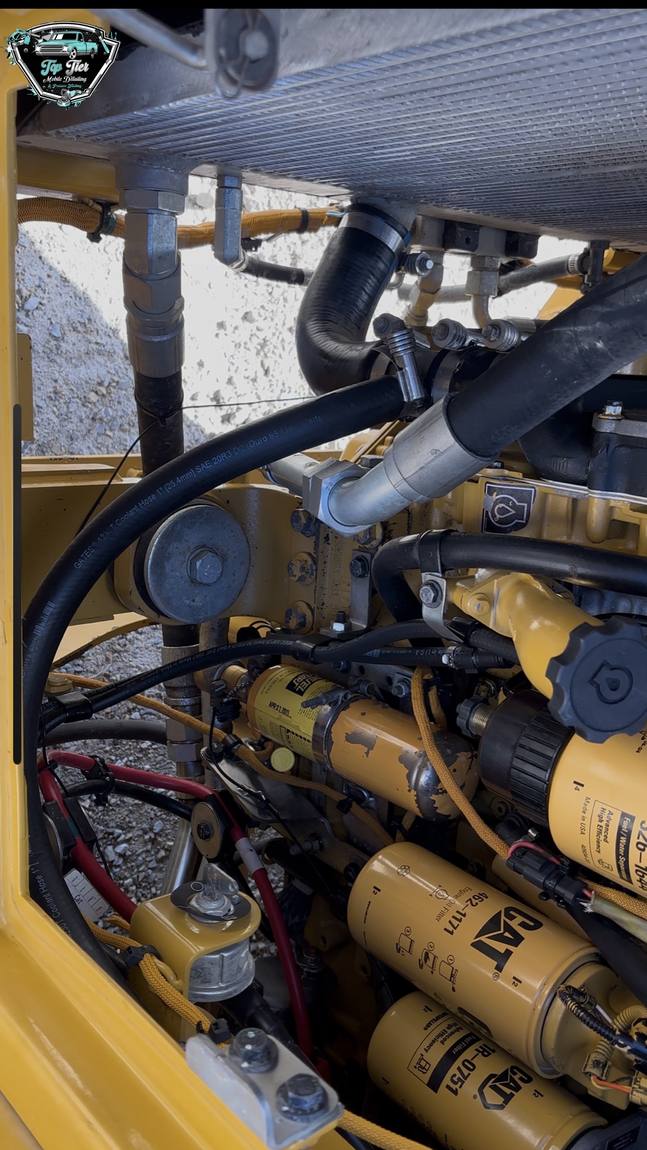 A degreased engine bay on a piece of yellow heavy equipment